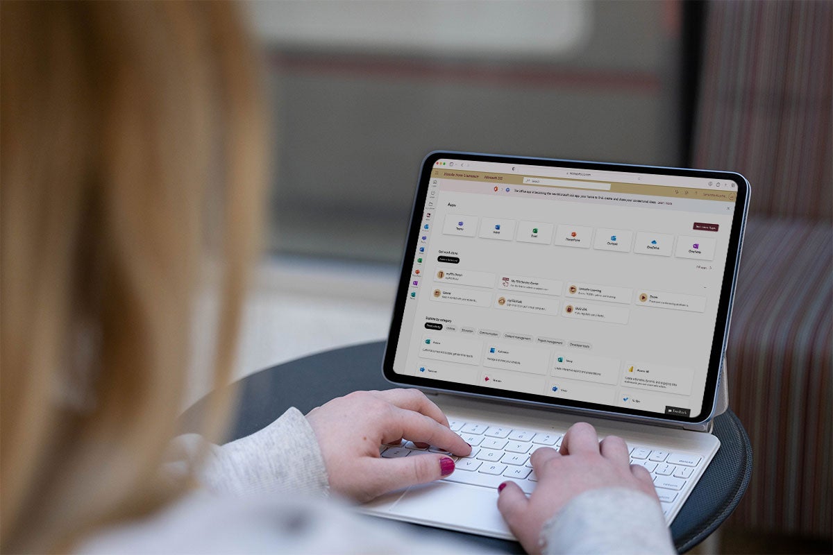 Female installing Microsoft 365 applications onto her device.
