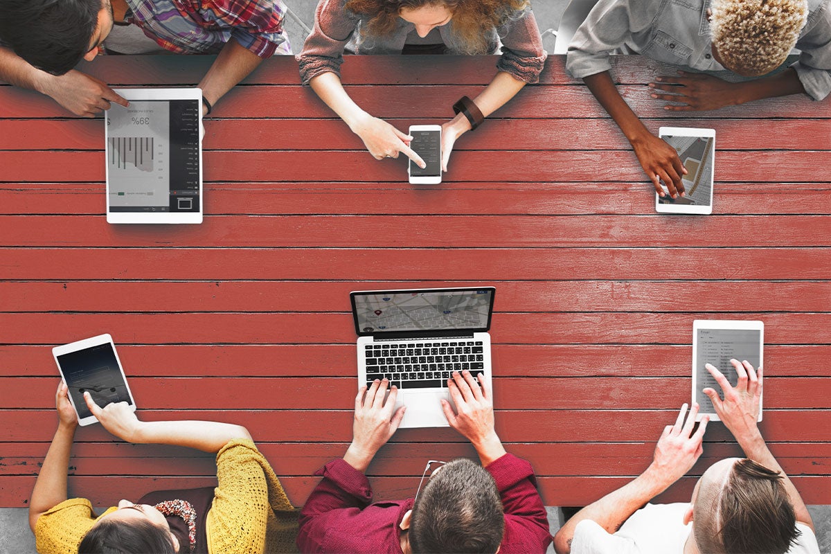 An aerial view of six students meeting and working together.
Female student sitting outside on a Zoom call.