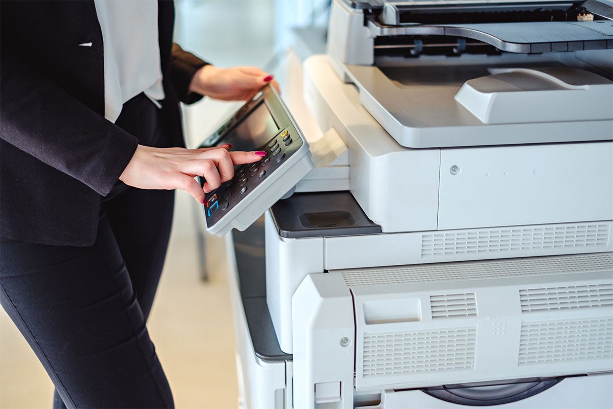 A close up of a female printing documents.