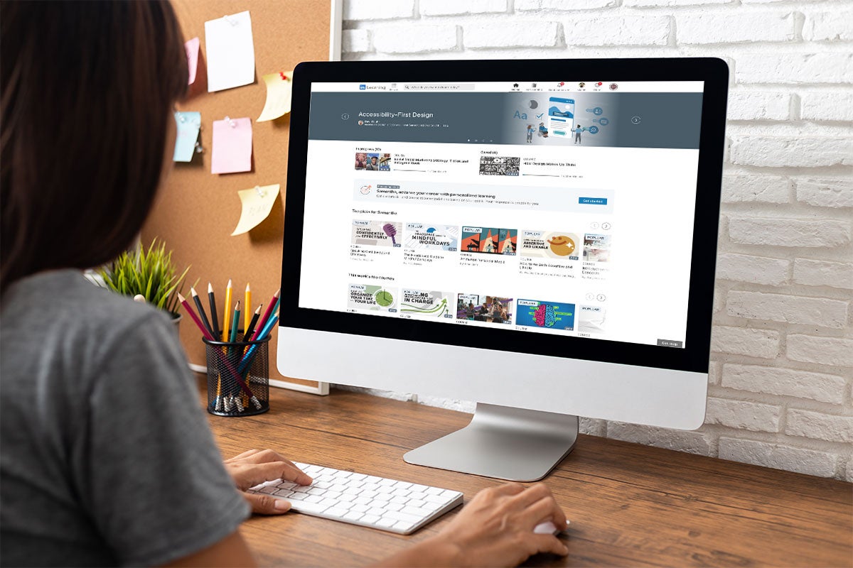 Female browswing LinkedIn Learning for new courses to take.