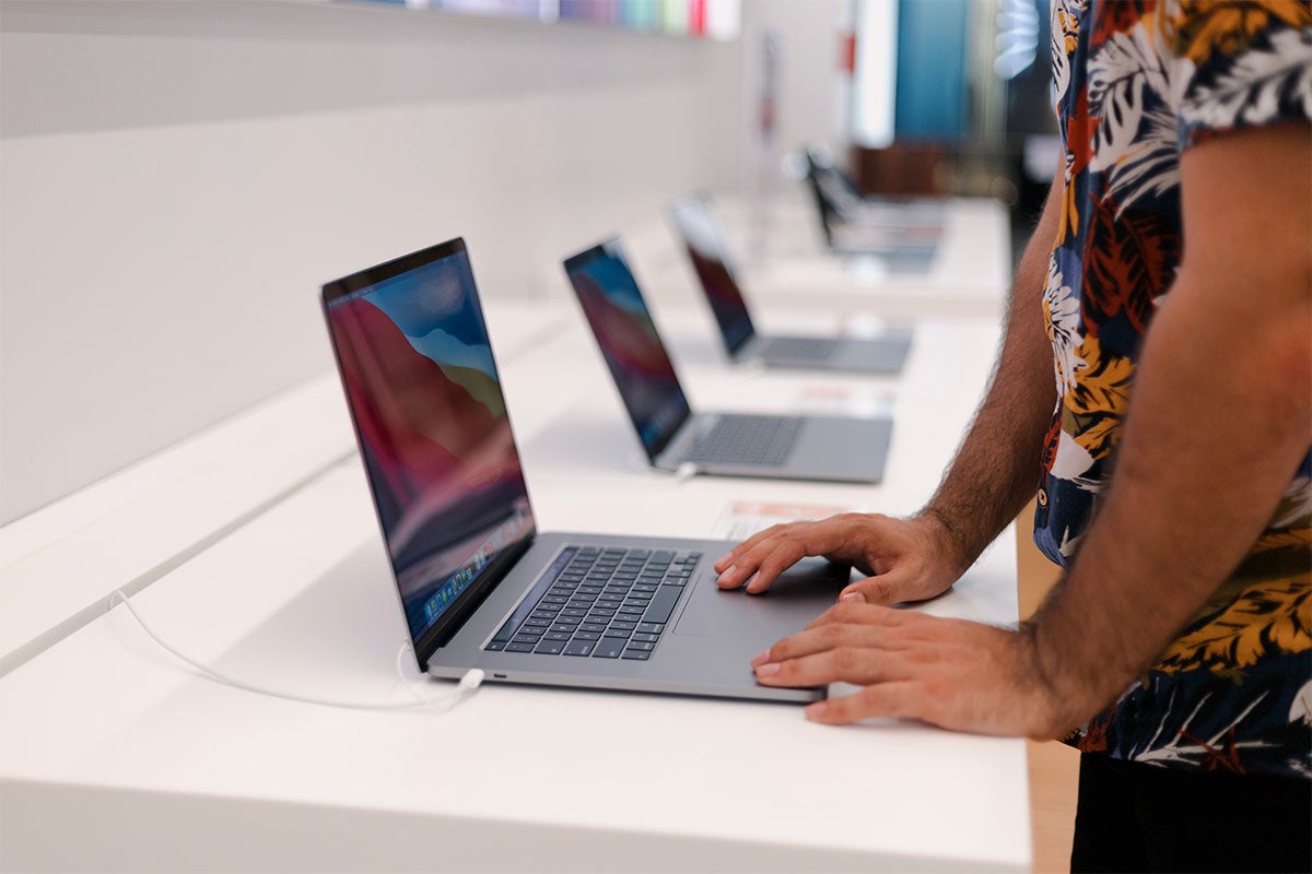 Close up of someone testing out a new laptop while shopping.